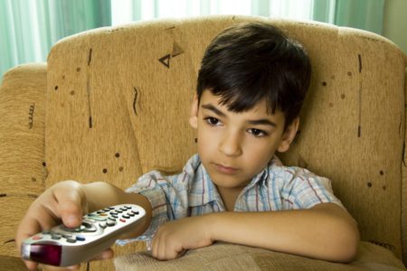 Latino kid remote TV eye health