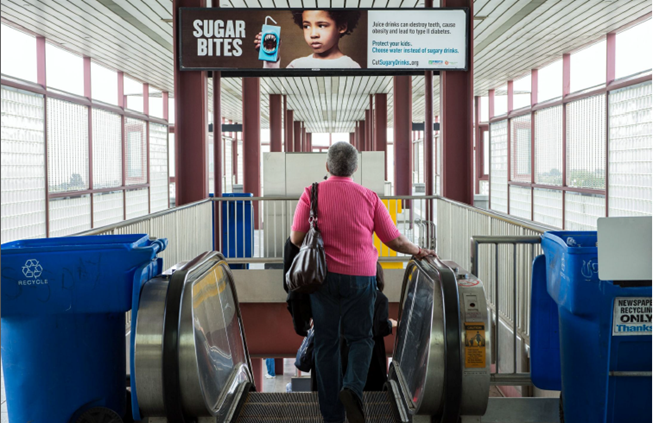 A photo showing a "Sugar Bites" ad in a pubic space