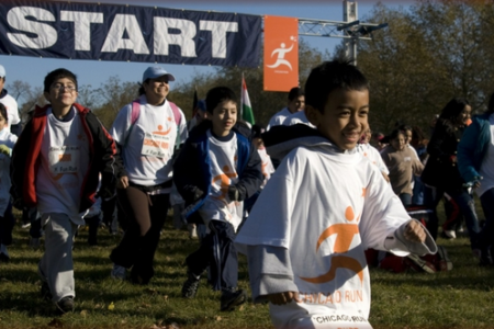 Children and adults smile as they participate in a Chicago Run fun run (Source: http://www.chicagorun.org/)