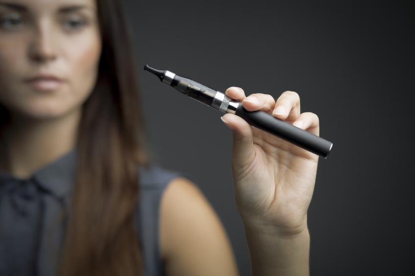 E-cigarette in woman's hand close up