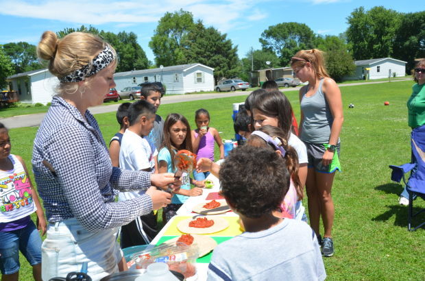 Emily Pence teaching cooking classes for kids over the summer in Fairbault with Tori Ostenso. (Photo source: Fairbault.com)