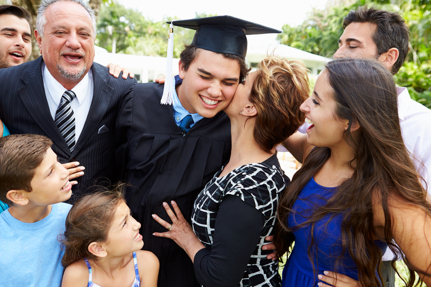 Hispanic Student And Family Celebrating Graduation