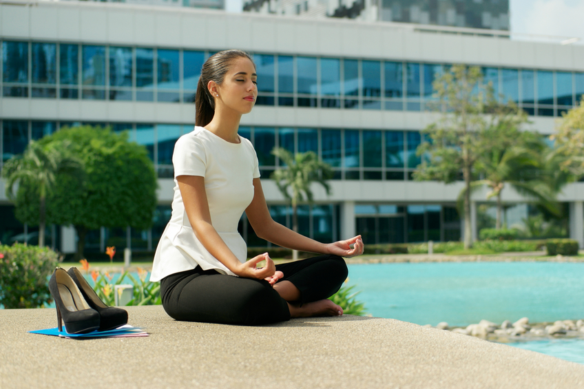 Latina Business Woman Doing Yoga Lotus Position Outside Office Building holistic health cancer prevention