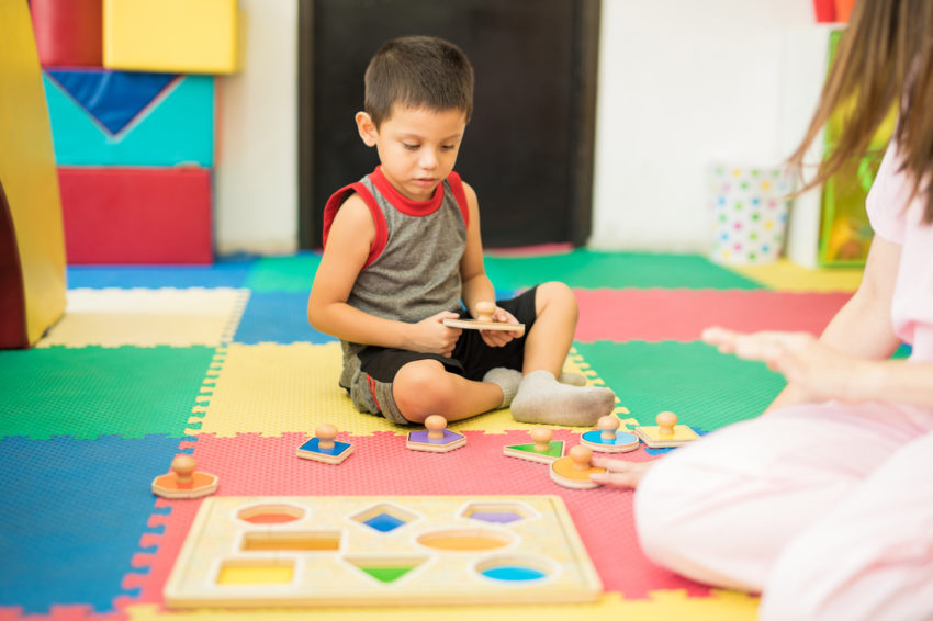 latino toddler boy shapes in preschool
