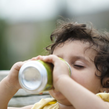 Latino toddler kid with sugury drink obesity