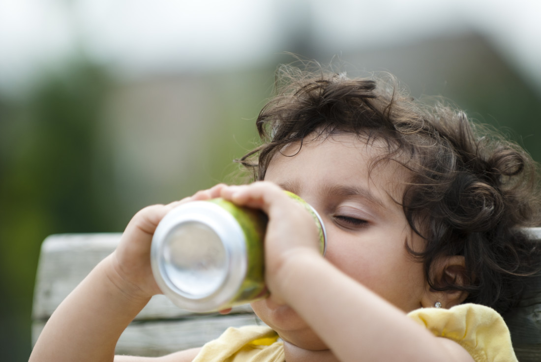 Latino toddler kid with sugury drink obesity