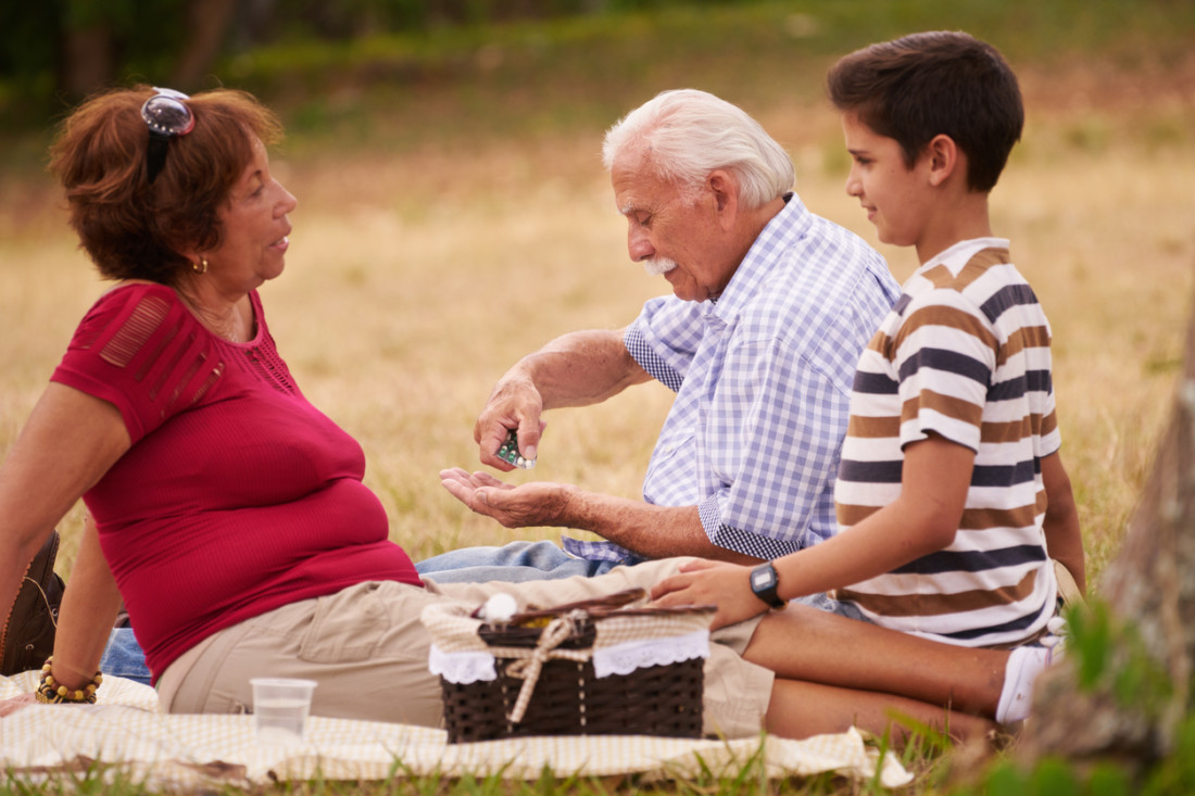 grandparents with latino boy picnic
