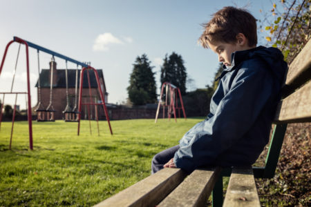 boy sad depressed bully bullying school playground sit system justification