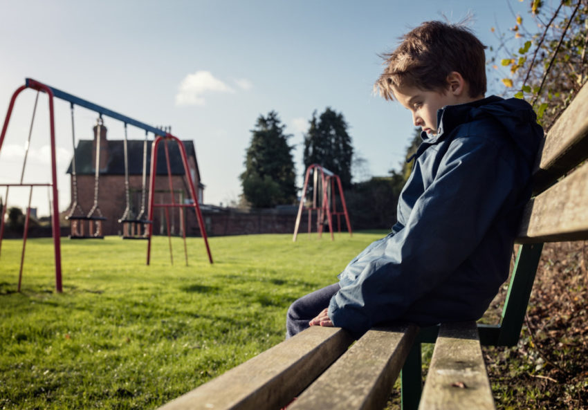 boy sad depressed bully bullying school playground sit system justification