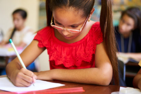 latina girl in school class homework glasses