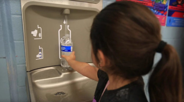 water bottle filling school latino girl