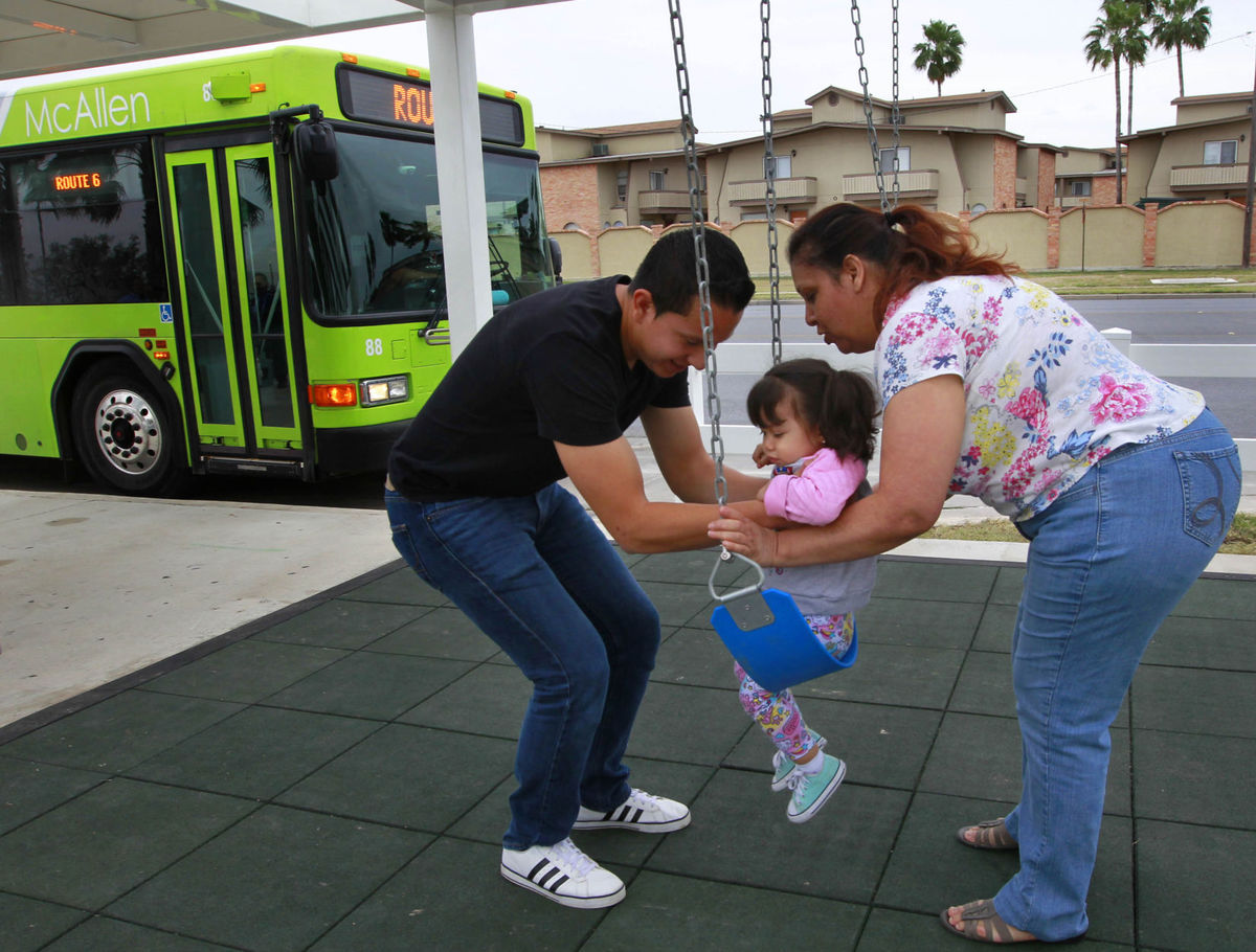 Parents and a child use the Metro McAllen "Swing and Rode" bus stop. (photo by Nathan Lambrecht of the McAllen Monitor)
