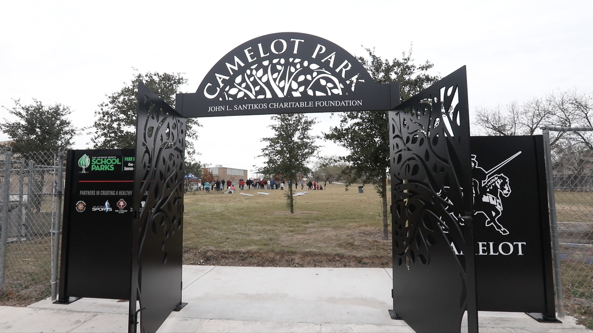 Children and families celebrate the installation of a new gate at San Antonio Sports School Park at Camelot Elementary on December 14, 2017.