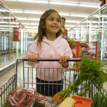 Latina girl grocery cart healthy food carrots obesity
