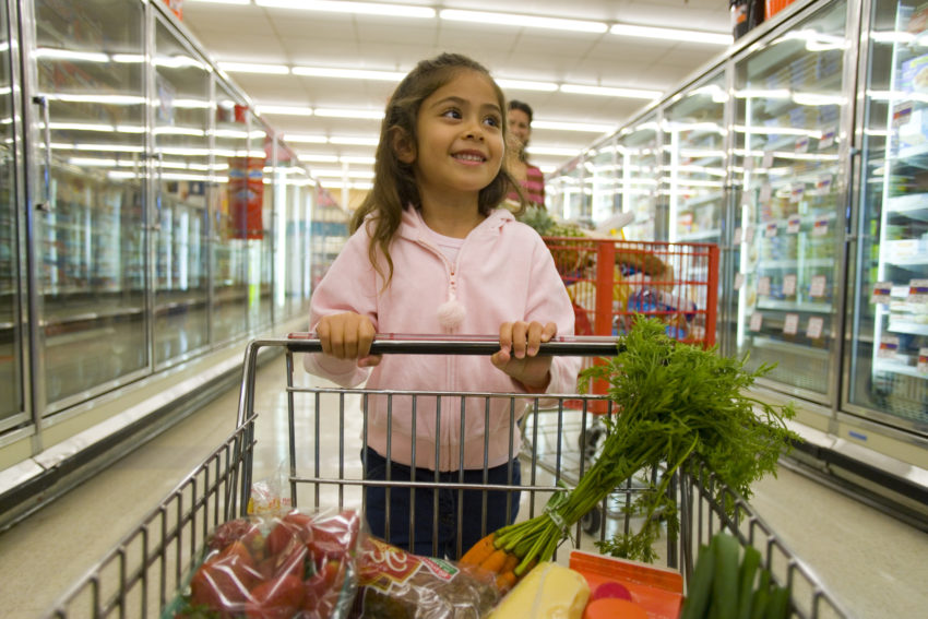Latina girl grocery cart healthy food carrots obesity