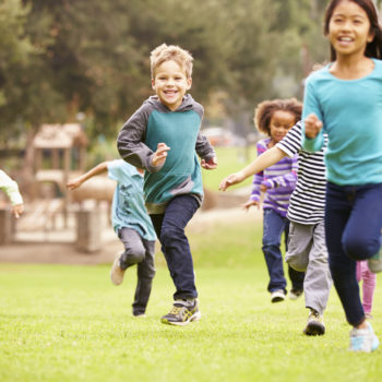 kids running park green space play