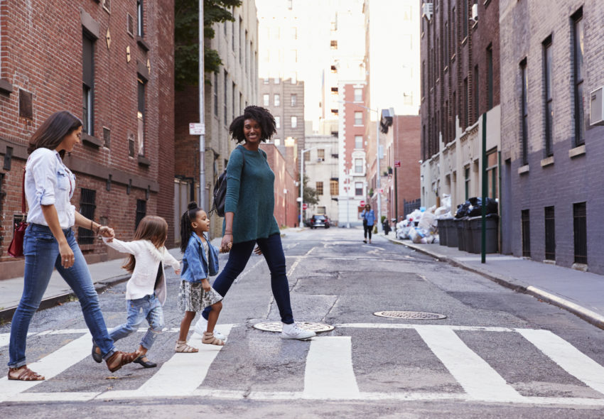 women and kids walking in urban city