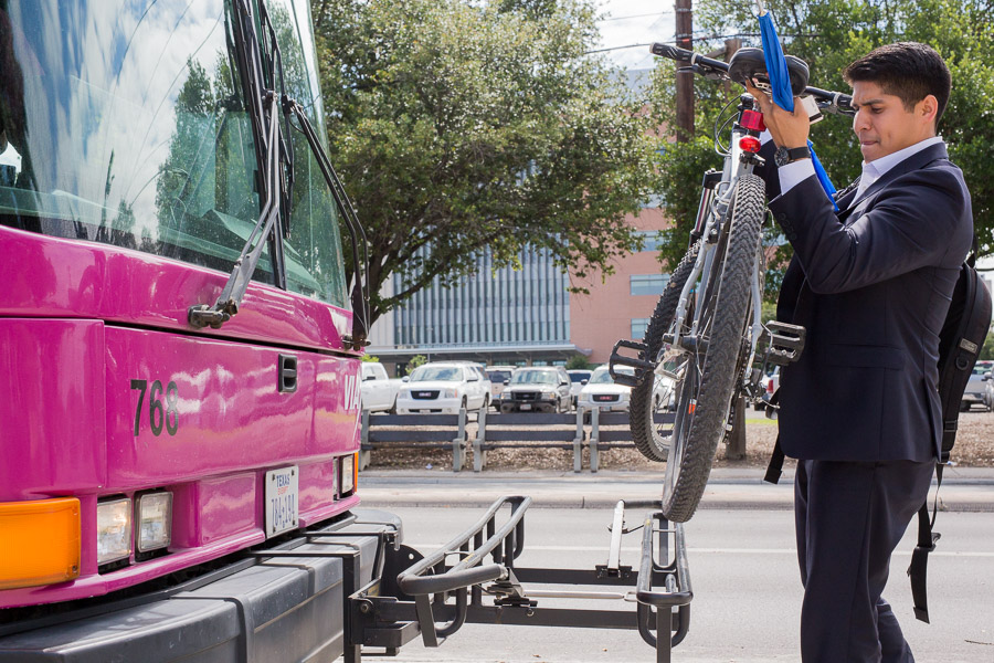 Councilman Rey Saldaña removes his bicycle from the front rack of a VIA bus Source Scott Ball Rivard Report