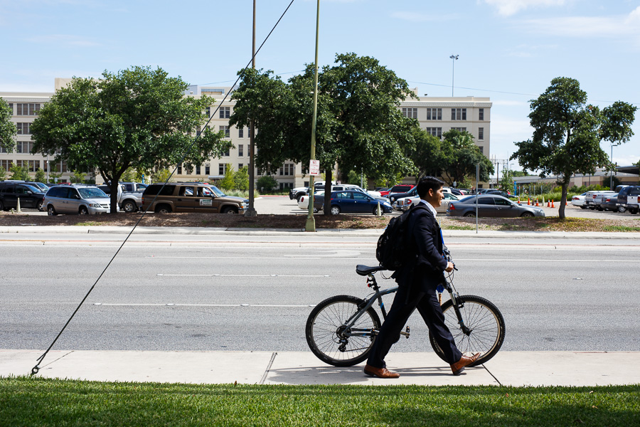 Councilmember Rey Saldaña walks his bike to a bus stop Source Scott Ball Rivard Report