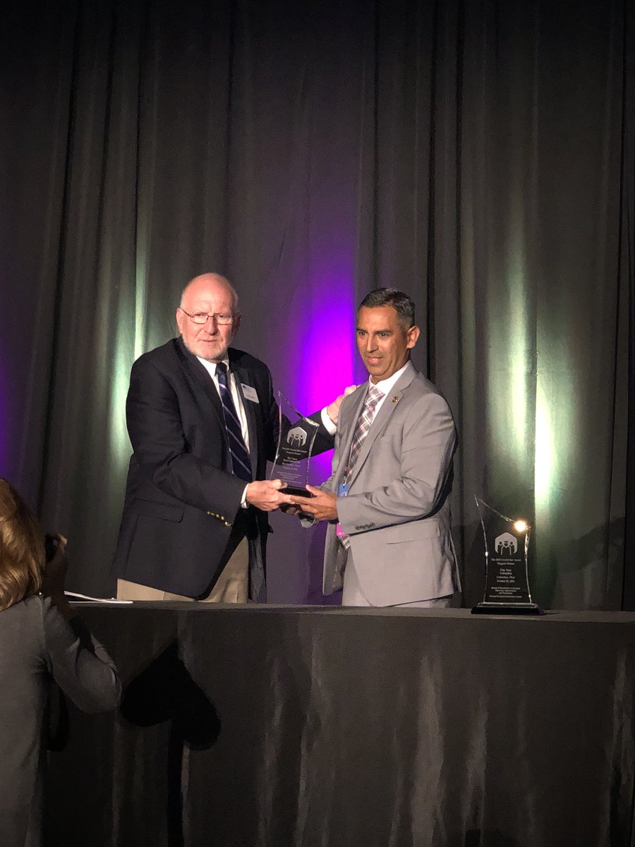 John Hernandez accepting the National Dropout Prevention Center (NDPC) Crystal Star Awards of Excellence in Dropout Recovery, Intervention, and Prevention on behalf of the EC Cares Committee. 