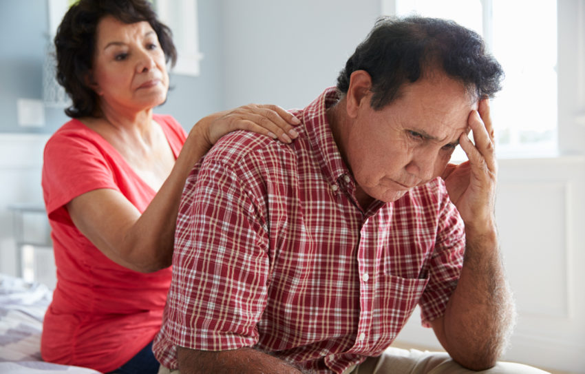 wife comforting latino immigrant husband stress depression