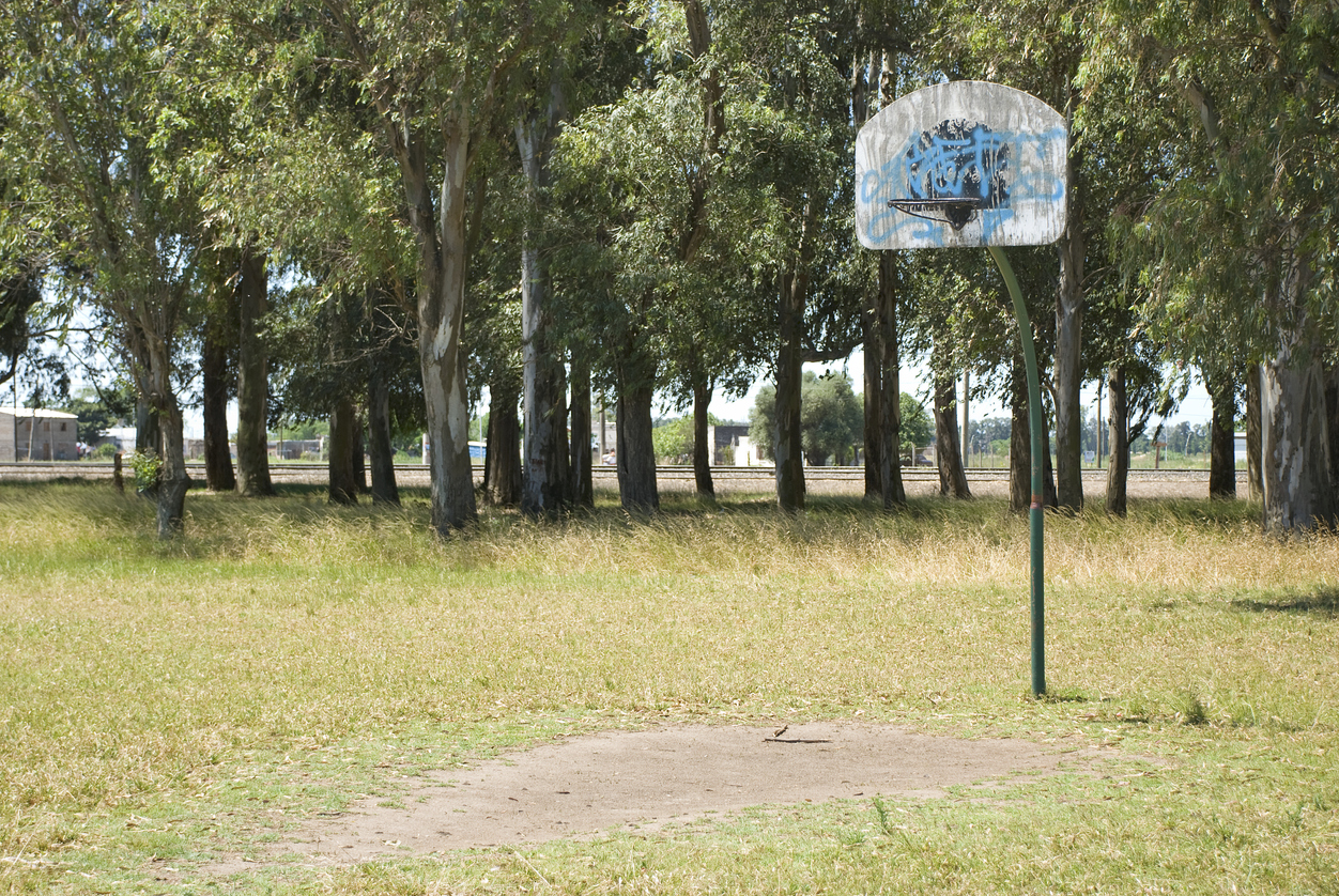Rundown basketball court in low-income neighborhood