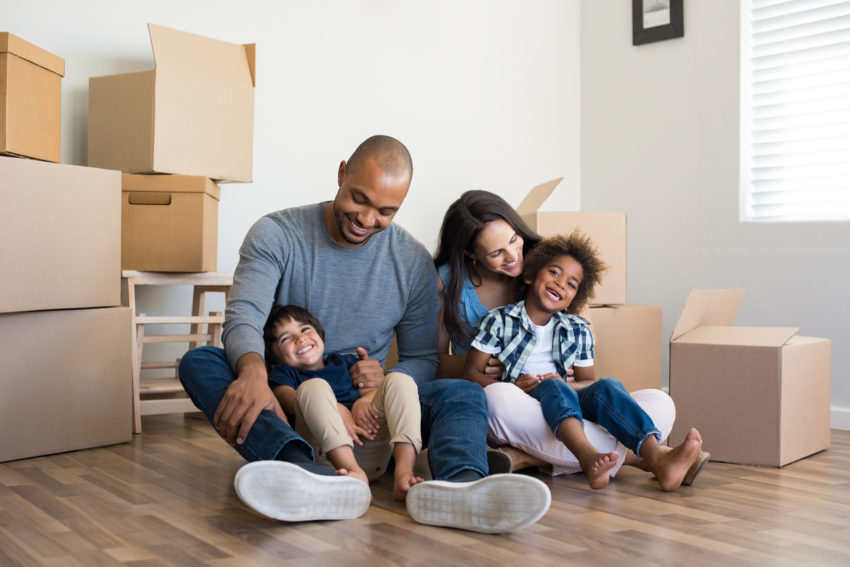 Latino minority family moving into affordable housing for health equity