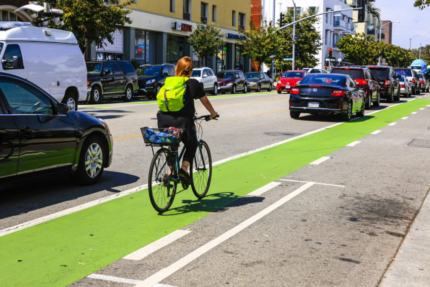 Cyclist riding the green bicycle lane