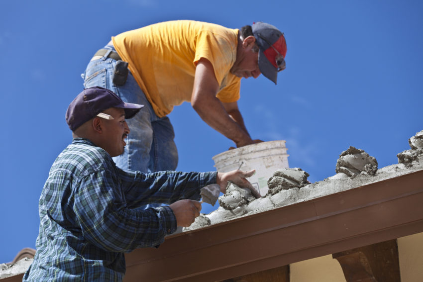 latino roof construction workers on the job