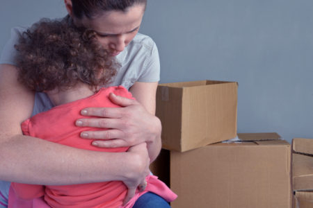 Sad evicted mother with child worried relocating house
