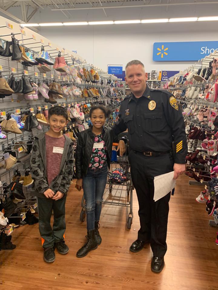 Chief Gault participating in Moline's Kids and Cops Holiday Shops program.