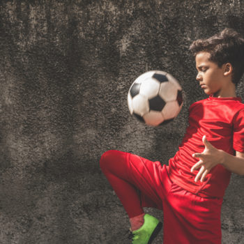 latino boy playing soccer futbol gettign physical activity kids