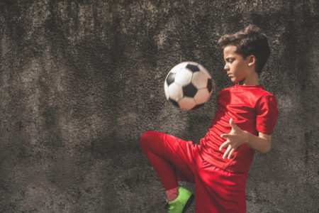 latino boy playing soccer futbol gettign physical activity kids