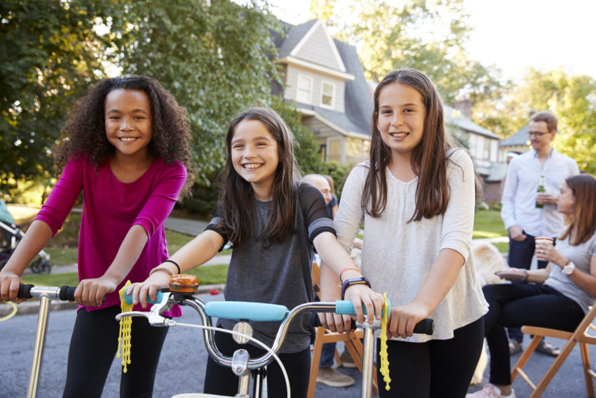 Diverse friends on bikes block party intergroup contact cohesive culture research review