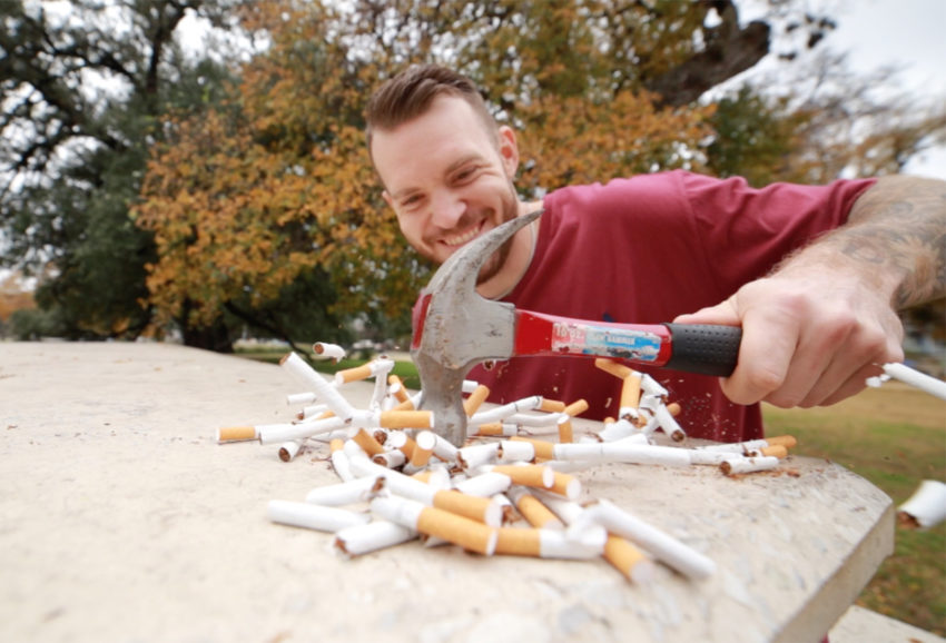 man quitting and stopping smoking by smashing cigarettes