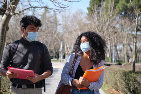 latino students walking outside with masks amid covid-19 coronavirus