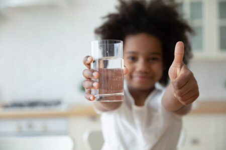 latino diverse child with clean drinking water