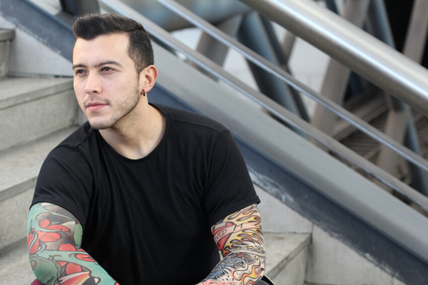 latino man substance abuse treatment contemplative tattoos