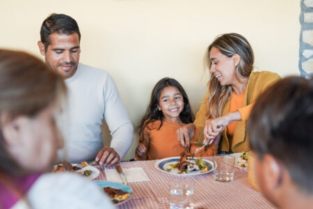Latino family eating dinner.