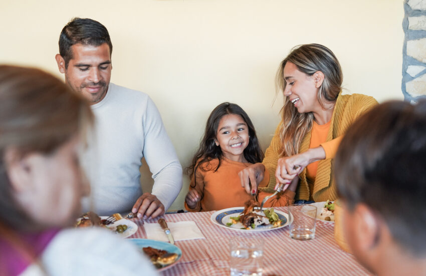 Latino family eating dinner.