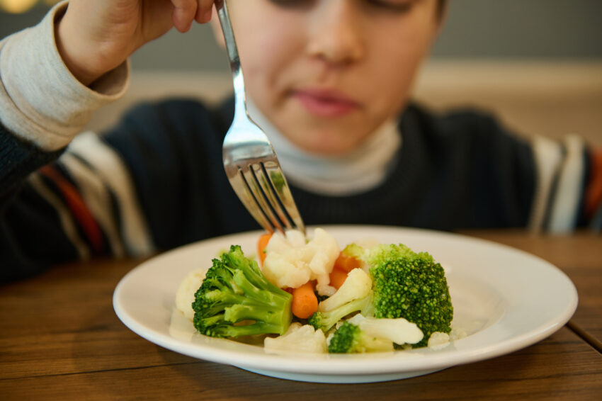 Child eating vegetables.