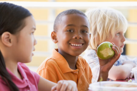 Child eating apple at lunch