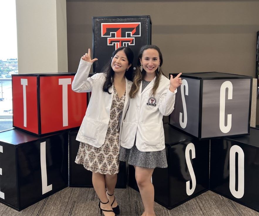 Gaby with a friend after receiving her white coat