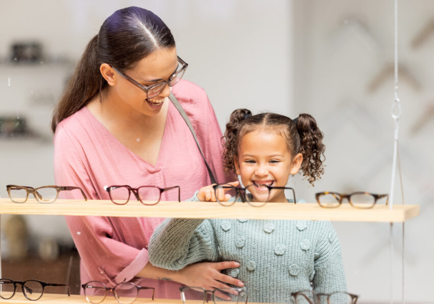 Decision, glasses and girl with her mother at the optometrist for vision and check on eyes together. Customer, medical and child shopping for eyeglasses with her mom at the ophthalmologist clinic