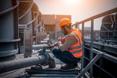 Industry engineer under checking the industry cooling tower air conditioner