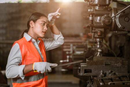 tired stress young woman worker sweating hard working in danger heavy metal industry