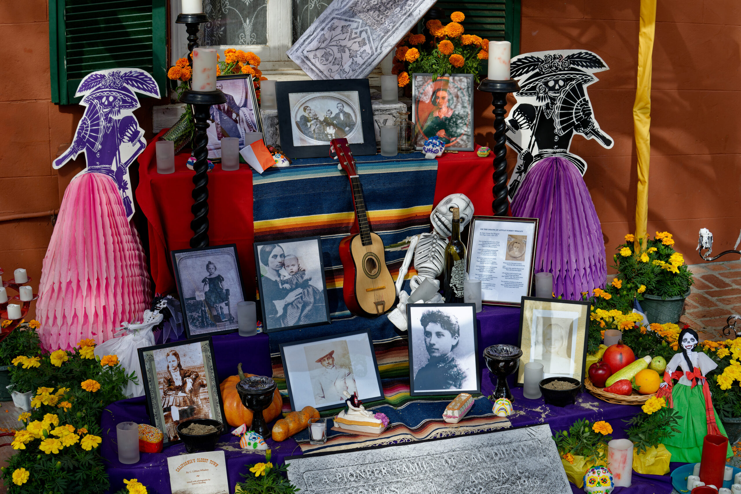 Day of the Dead (Día de los Muertos or Día de Muertos) altar (ofrenda) with skulls, candles, food, decorations, marigolds, and other offerings – Old Town, San Diego, California