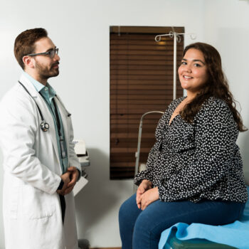 Portrait of a latin beautiful woman smiling while coming to the doctor's office for a medical check-up