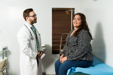 Portrait of a latin beautiful woman smiling while coming to the doctor's office for a medical check-up