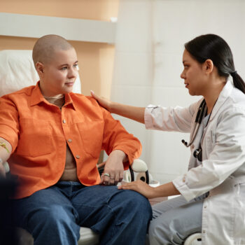 Nurse Comforting Patient Receiving Chemotherapy Treatment